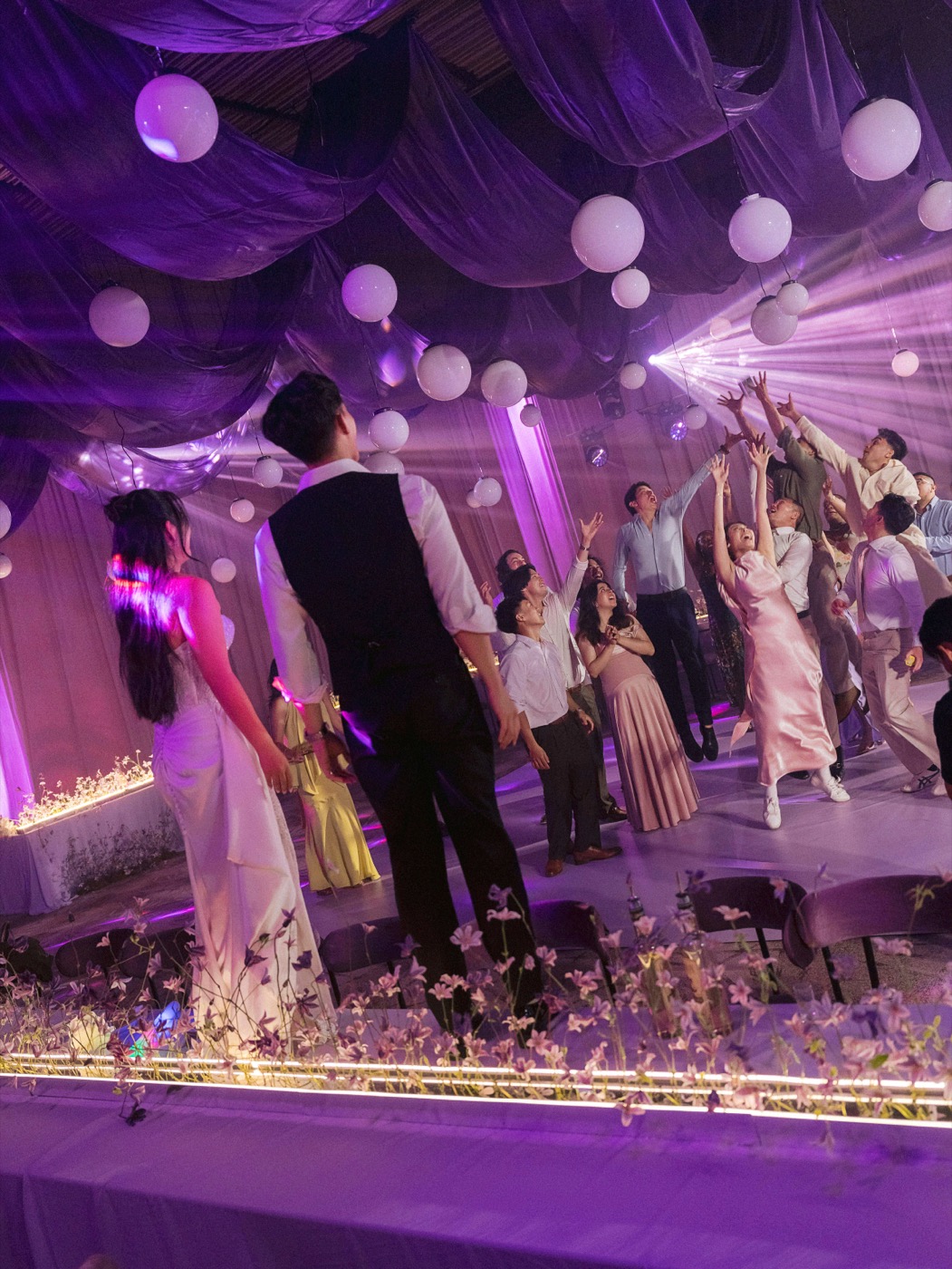 Bride and groom making their entrance under purple lighting