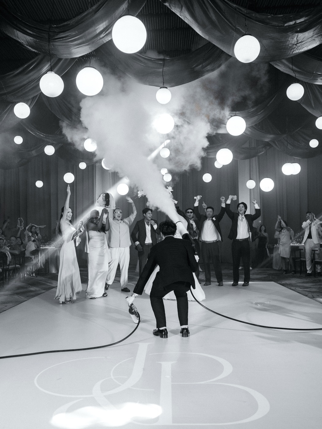 Black-and-white shot of a CO2 blast over the dance floor