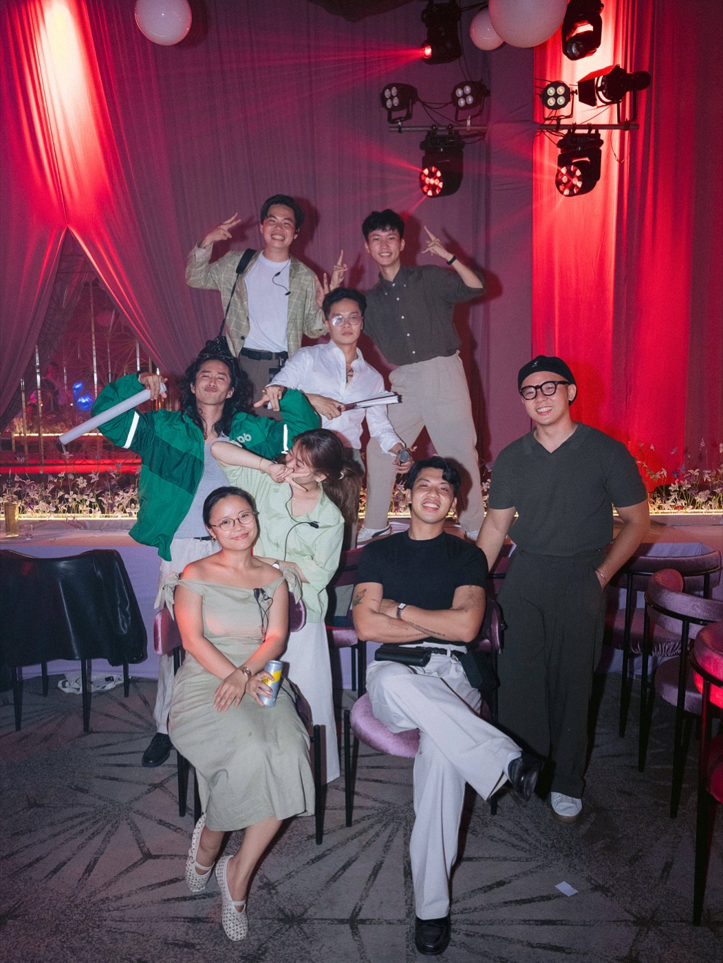 The wedding team posing under red lighting
